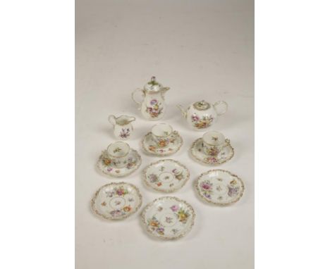 A MEISSEN PORCELAIN TEAPOT, COFFEE POT AND CREAM JUG with polychrome painted floral decoration within gilt borders, blue cros