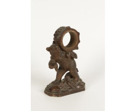 A BLACK FOREST TYPE CARVED WOOD BEAR with a tree trunk on his shoulder to fit a clock movement, late 19th/early 20th century,