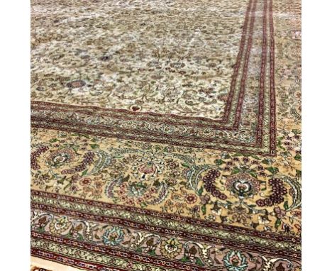 A CHINESE SILK RUG with floral scroll decoration on a pale brown, red and green banded ground. 138" x 101.5"Provenance: Purch