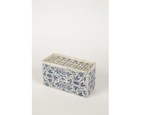 A DELFTWARE TIN GLAZED FLOWER BRICK with blue painted floral decoration on white ground, 18th century, 3.5" high x 6.25" wide
