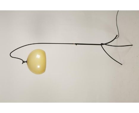 IN THE MANNER OF GUZZINI: A STANDARD LAMP, the globular tinted shade with ironwork frame, 66" high