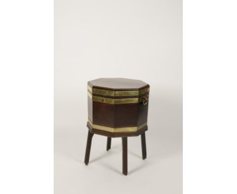 A GEORGE III MAHOGANY WINE COOLER of octagonal shape, the top with a caddy moulded edge, brass banded and with bold loop hand