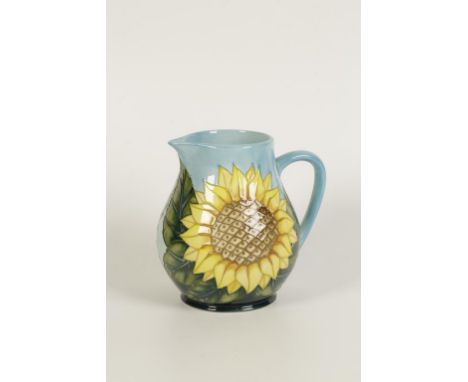 A MOORCROFT POTTERY JUG "SUNFLOWER" of bulbous form with single "C"-shaped handle with tubeline sunflower decoration, designe