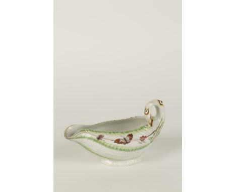 A WORCESTER PORCELAIN SAUCEBOAT of lettuce leaf form with a looped stem handle, painted with scattered flower sprigs and inse