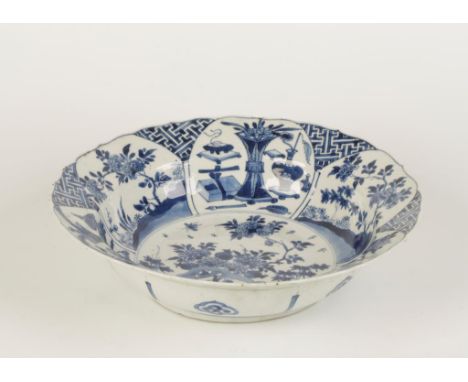 A CHINESE BLUE AND WHITE SMALL BASIN with a barbed flared rim, the centre painted with flowering and fruiting plants issuing 