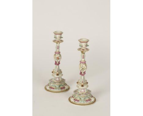 A PAIR OF "MEISSEN" PORCELAIN CANDLESTICKS of classical form with panels of painted birds on a stepped ornamental base, blue 