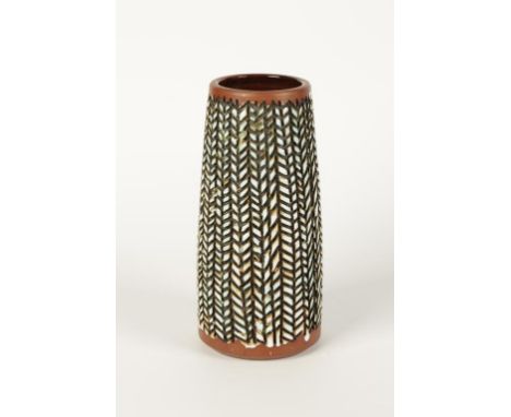 A POOLE POTTERY ATLANTIS VASE of tapering cylindrical form, shape no. A20/5 with carved abstract decoration, glazed in tones 