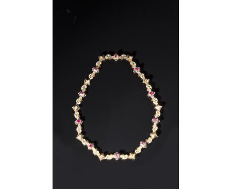 A HOLBEINESQUE GEM SET AND ENAMEL NECKLACE set with rubies and diamonds interspersed with panels of scroll work picked out in