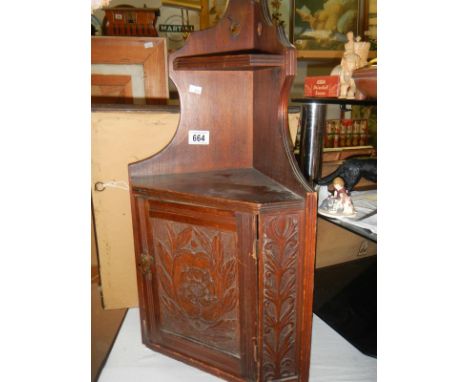 A vintage wooden corner shelf unit