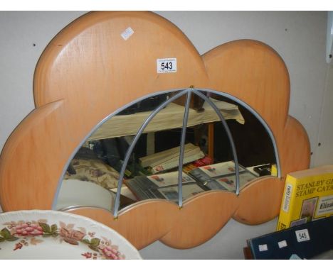 A mirror on wooded surround in the shape of a cloud