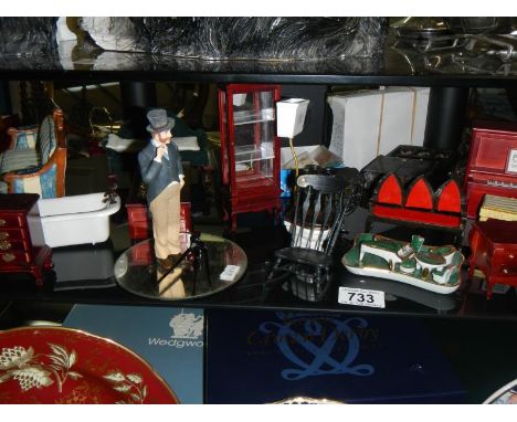 A shelf of miniatures and dolls house items