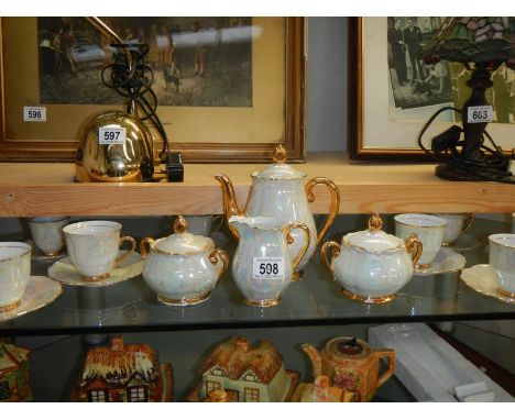 A 6 setting Continental lustre tea set with teapot, sugars and milk