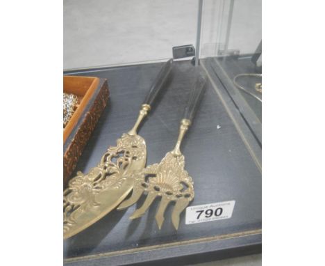An ornate serving fork and cake slice