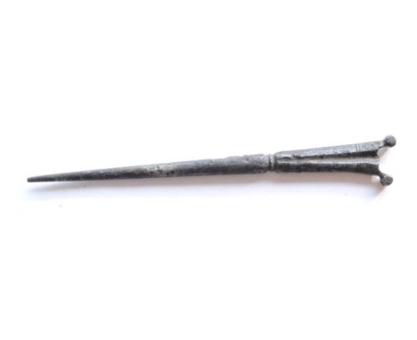 A 17th Century Steel Bodkin (Gun Cleaning Needle), of stiletto form with flat fluted gunstock type finial with two rolled fin