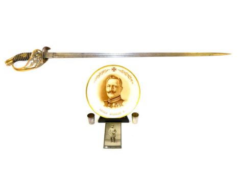 A Prussian Infantry Sword, the 77cm single edge double fullered steel blade stamped with W K & C logo, the brass hilt pierced