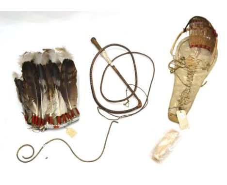 An Early 20th Century Southern Plains Indian Eagle Feather Headdress, the felt cap with buckskin bound sweatband set with a b