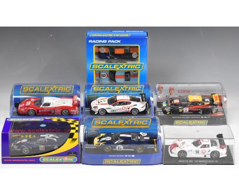 Eight Scalextric model slot racing cars comprising six individual and one twin car set. Models include Maserati MC12, Aston M