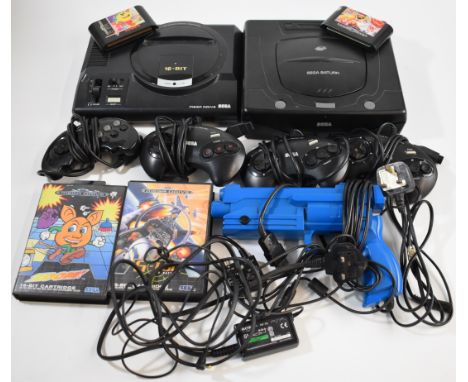 Two retro games consoles comprising Sega Mega Drive and Sega Saturn together with controllers, light gun and 5 games.
