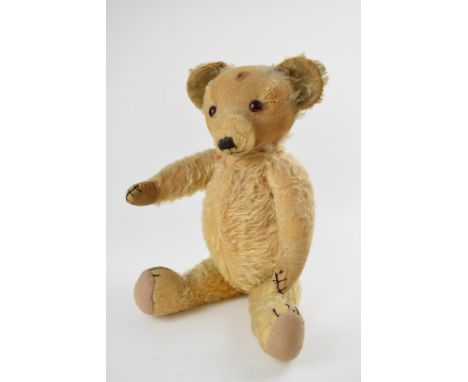 Merrythought Teddy bear, with button in ear, blonde mohair, brown and black glass eyes, swivel head, jointed limbs, shaved sn