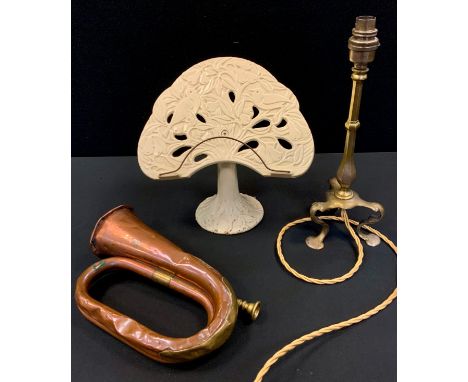 An Art Nouveau brass table lamp;  cast iron tree of life book stand;  a copper bugle (3) 