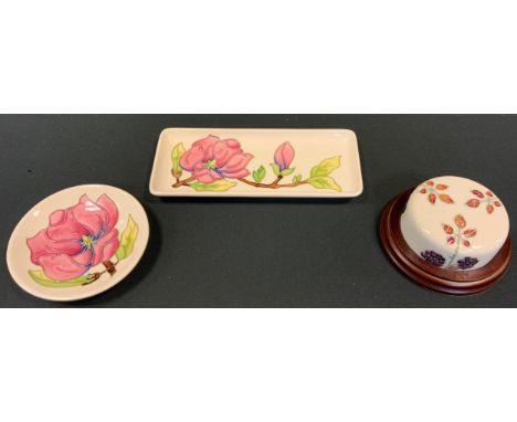Moorcroft - a Blackberry pattern desk weight, wooden base, 10.5cm diameter;  Magnolia rectangular trinket tray, another circu