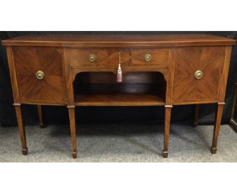 A George III style mahogany angular bow front sideboard, with central drawer, open shelf flanked by two cupboard doors, 168cm