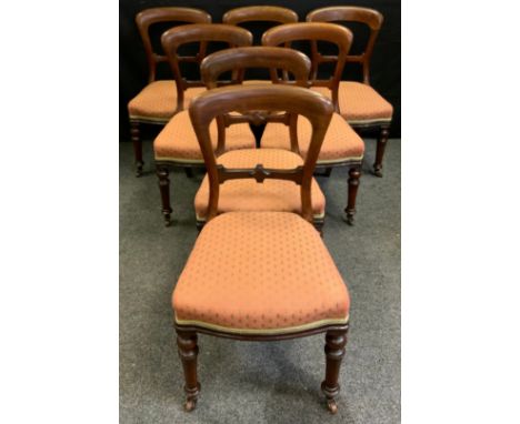 A set of seven mid-Victorian mahogany balloon-back dining chairs, upholstered seats, turned legs, ceramic casters, c.1860-70.