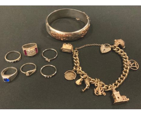 A silver coloured metal charm bracelet, eight charms, padlock clasps, mostly unmarked, 48g;  silver and rose gold hinge bangl