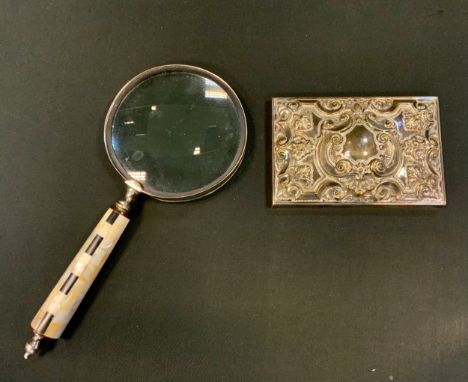 A large magnifying glass, mother of pearl and black onyx handle;  a silver plated panel. 