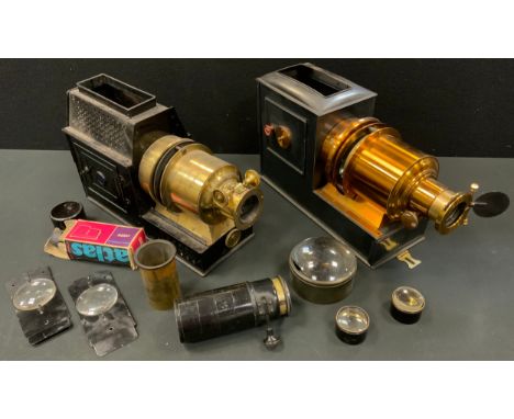 A late Victorian lacquered brass and black painted magic lantern, c.1890;  another, both cased;  various lenses (2) 
