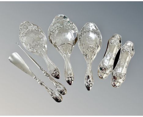 A Edwardian seven-piece silver dressing table set comprising of two pairs of brushes, hand mirror, shoe horn and button hook,