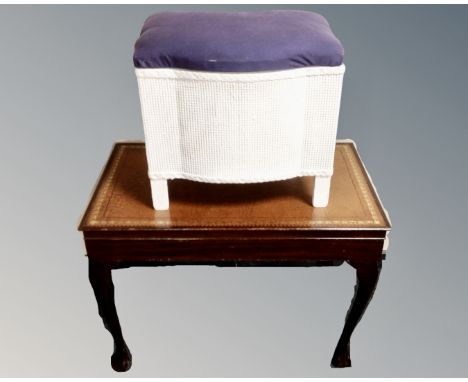 A cutlery table with raised legs and inset leather panel together with loom linen box