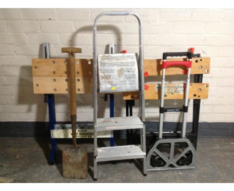 Two folding work benches together with a garden spade, folding light weight sack barrow and three tread aluminium folding ste