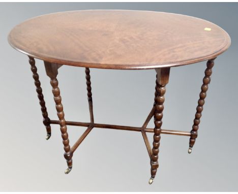 A 19th century oval inlaid occasional table on bobbin legs with brass feet 