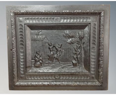 A heavily carved and ebonised oak wall panel 