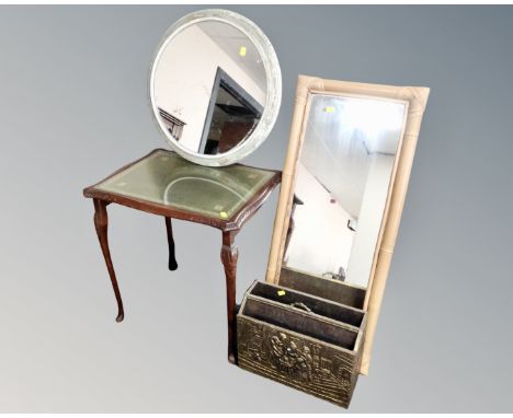 A stained beech occasional table with leather inset panel and glass top together with two wall mirrors and brass embossed mag