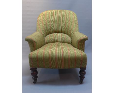 A Victorian spoon back arm chair upholstered with green and red stripped fabric, raised on turned mahogany legs and castors. 