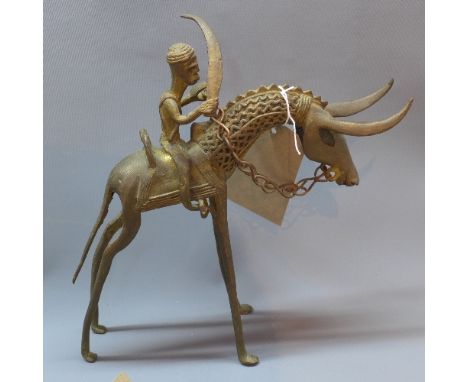A Benin style cast bronze study of a figure on a horse