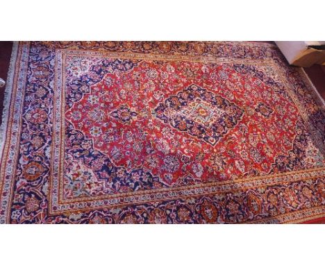 A fine Central Persian Keshan carpet, double pendant medallion with repeating spandrels on a rouge field within stylised sapp