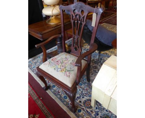 A pair or early 20th Century Chippendale style armchairs with tapestry upholstered seats and raised on ball and claw feet