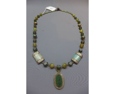 A ladies Egyptian jade and Nubian white metal necklace, hanging oval and white metal pendant inset with jade. 