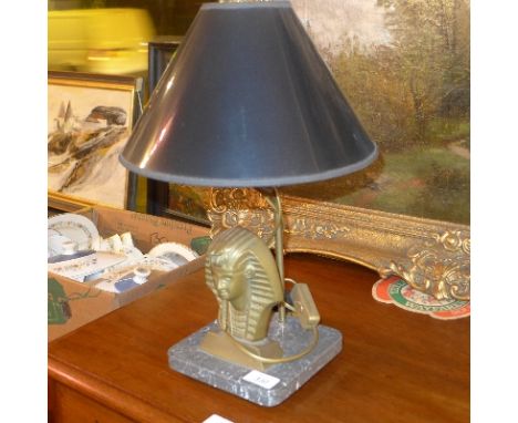 A brass pharaoh table lamp, with black shade on a marble base, H:45cm