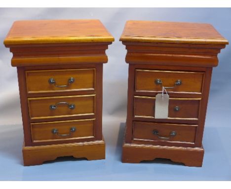 A pair of contemporary teak side chest of three drawers raised on bracket feet, H:66cm W:45cm D:38cm