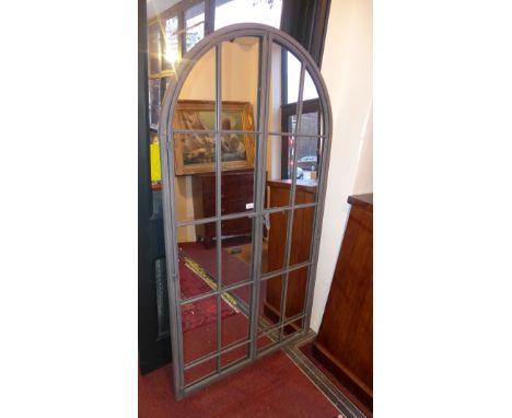 An arch top garden mirror with gate