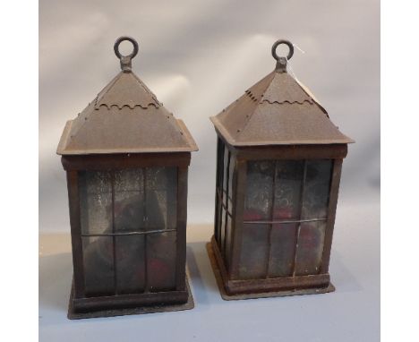 A pair of vintage cast iron storm lanterns