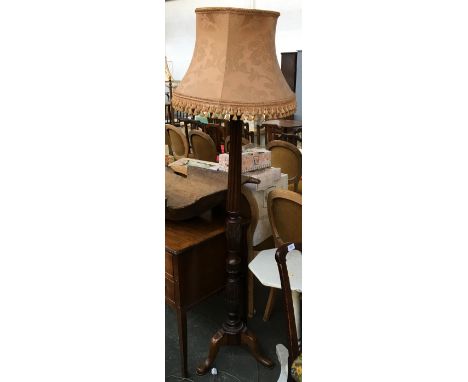 An Edwardian standard lamp on reeded column with wheat sheath carving on cabriole legs 