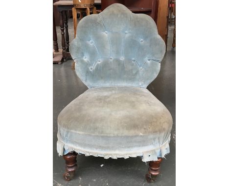 A button back salon chair on turned front legs and casters 