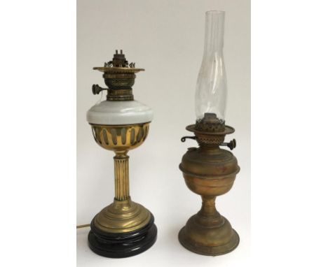 A brass duplex oil lamp with glass chimney, together with a brass oil lamp, milk glass reservoir on reeded column base (conve