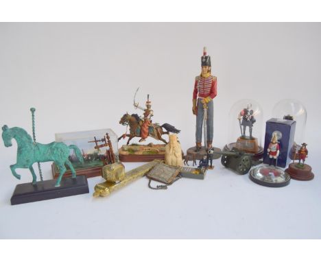 A selection of military and cavalry related items including resin soldier figurines of various sizes, toy cannon, paperweight