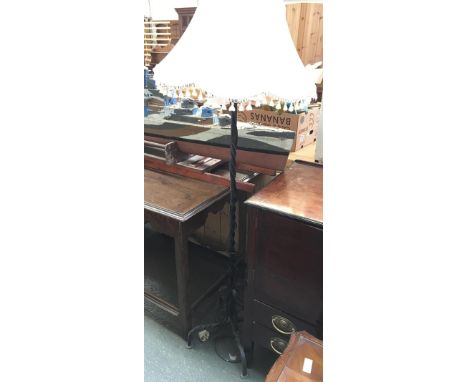 A wrought iron standard lamp, with shade 